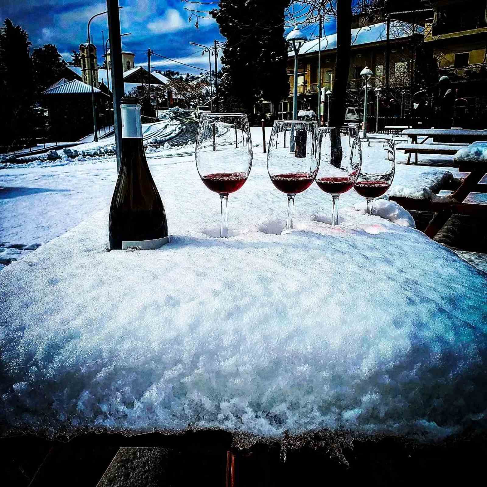 Glasses of red wine in the snow